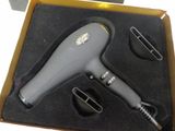 a hair dryer that is in a box on a table