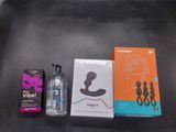 a bottle of water, a box of condoms, and a box of condoms on a table