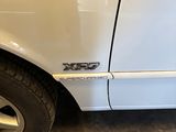 a white car with a red stripe on the side of it