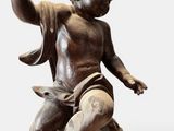 an image of a statue of a child sitting on top of a rock