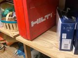 a red box on a wooden shelf in a room