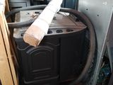 a stack of old appliances in a room with a lot of junk