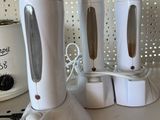 four white blenders sitting on a counter next to a crock pot