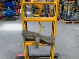 a yellow hand truck with a rope on it in a warehouse