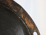 a close up of a metal plate with a hole in it
