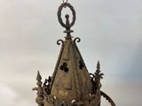 a metal birdhouse with a bird on top of it