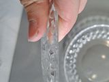 a person holding a piece of clear glass in their hand