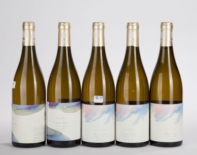 six bottles of wine are lined up in a row on a table