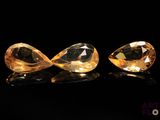 a pair of yellow sapphires on a black background