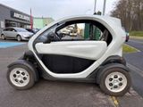 a small car that is parked on the side of the road