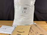 three bags of white bags sitting on top of a wooden table
