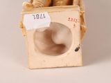 an image of a figurine of a man sitting in a box with a sign on it
