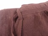 a close up of a brown sweater with a tie on it