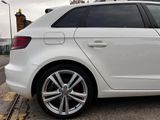 a white car that is parked on the side of the road