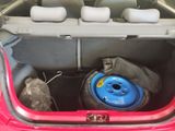 a car trunk with a tire and a bag in it