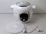 a white and silver electric rice cooker on a table