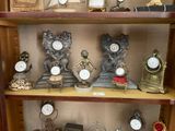 de nombreuses horloges différentes exposées sur une étagère dans une pièce