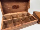 a small wooden box with compartments inside of it