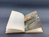 an open book with a picture of a boat on it