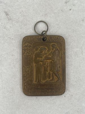 an image of a metal pendant with a picture of a man and a woman