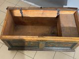 an old wooden chest with a metal latch on it