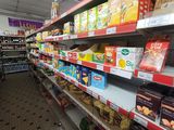 many shelves in the store with different types of food on them