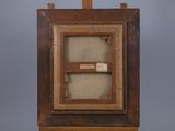 an old wooden easel with a piece of paper on top of it