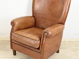 an image of a brown leather chair sitting on a tiled floor