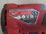 the milwaukee milwaukee m18 fid2 corded drill is laying on the floor