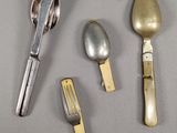 three spoons, a fork, and a knife on a table