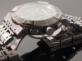 a close up of a watch on a metal bracelet