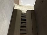 a door open to a small refrigerator in a room