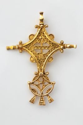 a close up of a cross on a white surface