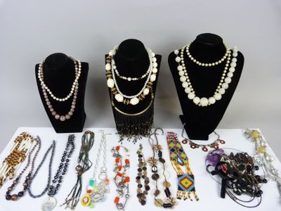 several necklaces and bracelets are displayed on display on a table
