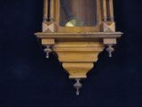 a clock hanging on the wall with a black background