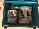 a blue tool box with a drill and a charger in it