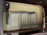 a tray with silverware in it and a spoon in it