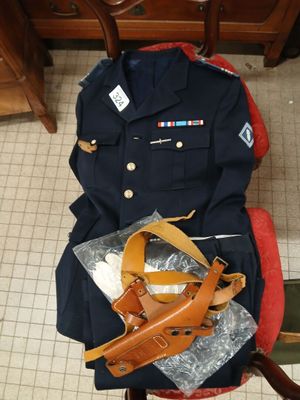 a uniform that is sitting on a chair next to a bag