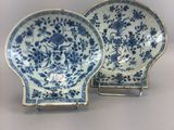 two blue and white plates with flowers on them
