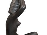 statue of a woman sitting on her knees holding a vase