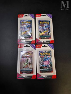 four packs of pokemon trading cards on a black table