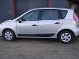 a picture of a small silver car parked in a parking lot