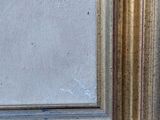 a close up of a painting of a gold frame on a white wall