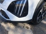 the front end of a white suv parked in a parking lot