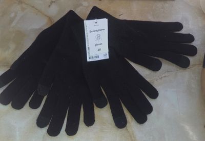 a pile of black gloves sitting on a table