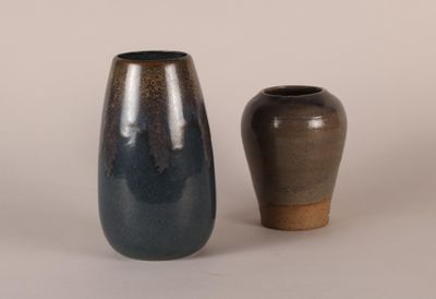 two vases sitting next to each other on a table