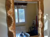 a mirror hanging on the wall above a sink