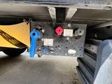 a close up of a truck with a yellow and blue sign on it