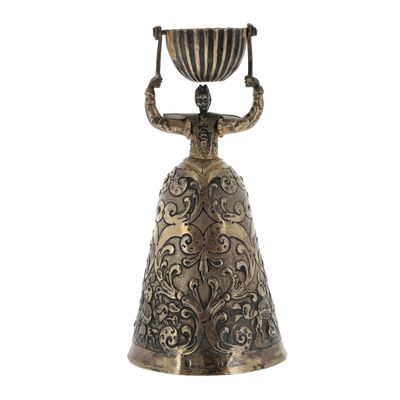 an image of a brass bell with a woman holding a bowl