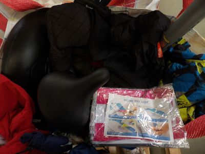 a baby car seat filled with clothes and other items